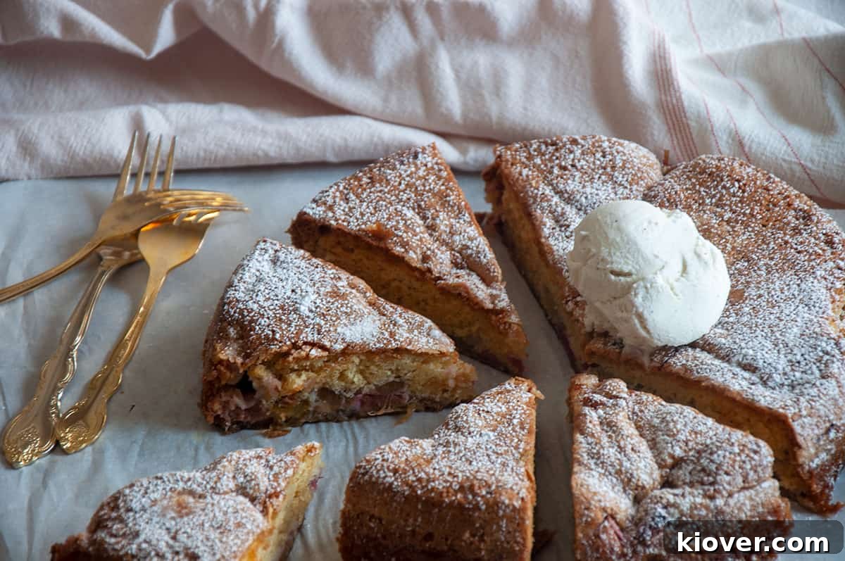 Rhubarb Cake Rhubarb cake cut into pieces with a dollop of whipped cream on top, ready to serve!