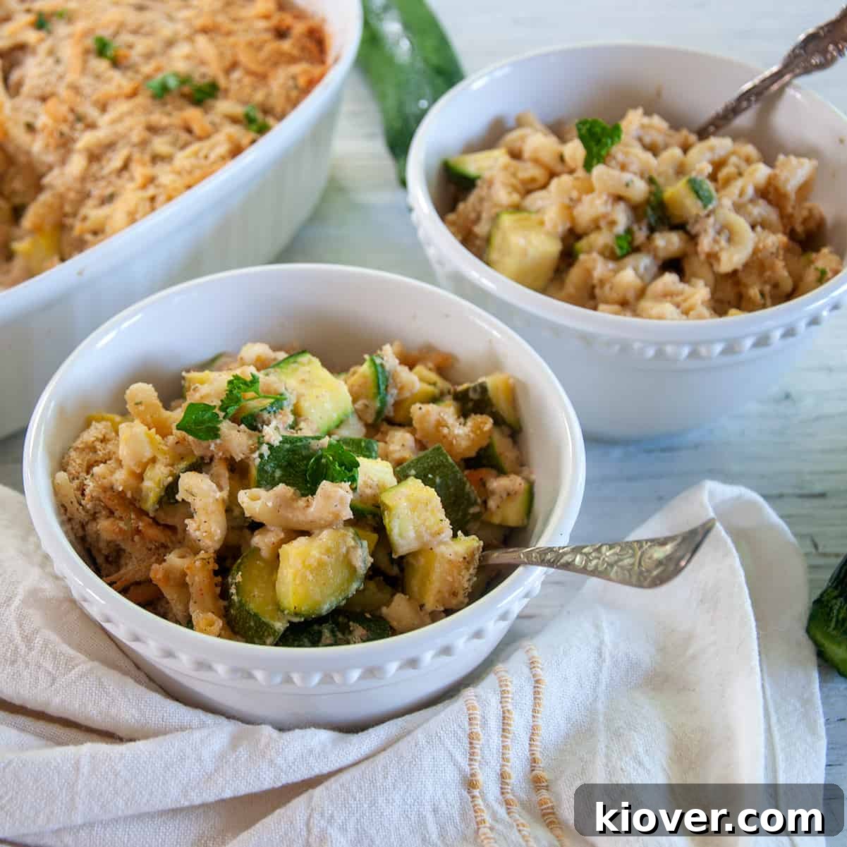 Bowl of Italian Zucchini Casserole in a white dish with spoon.