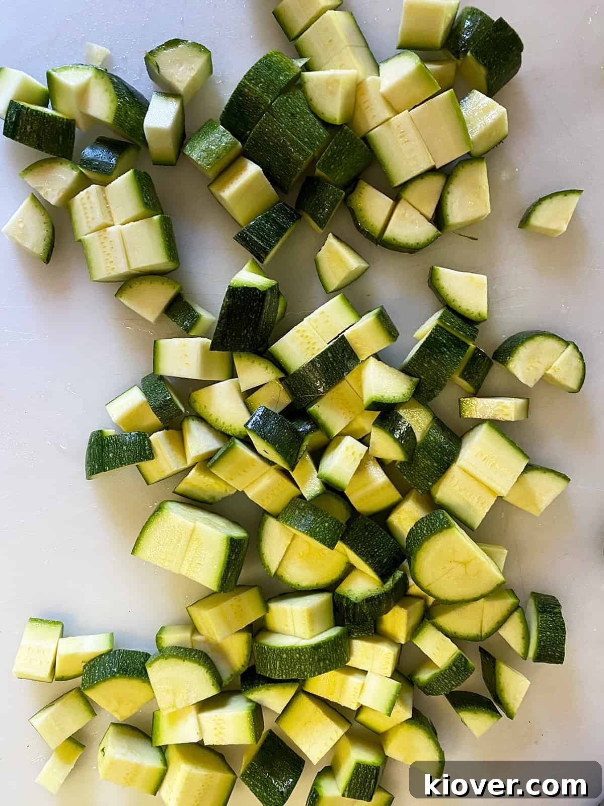 Chopped zucchini on a cutting board.