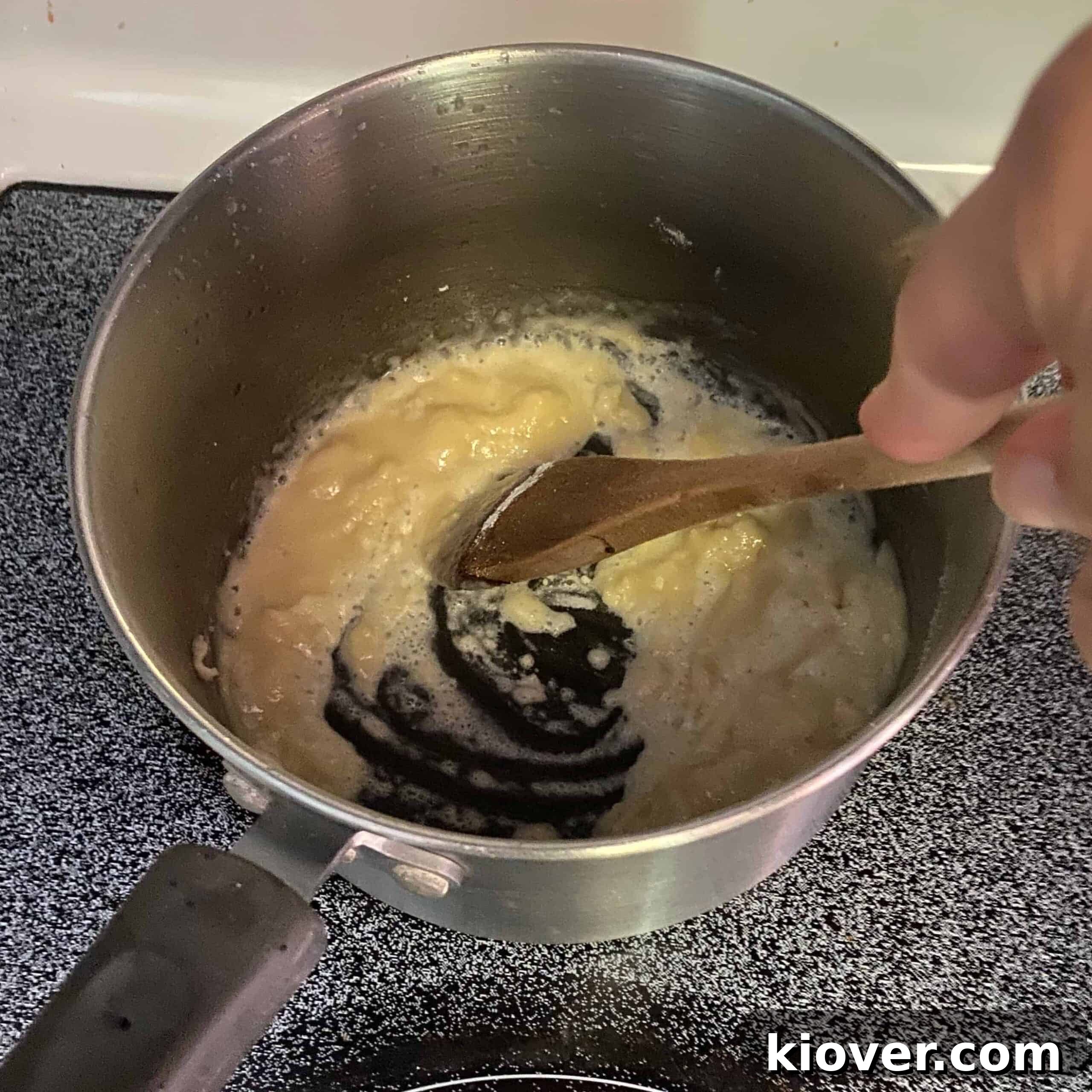 Sauce pan with butter and flour being mixed into a paste.