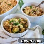 Bowl of Italian Zucchini Casserole in a white dish with spoon.