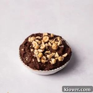 A bowl of rich, smooth homemade Nutella spread, highlighting its creamy texture.