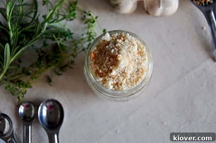 Overhead view of homemade breadcrumbs in a glass jar, demonstrating their fine texture.