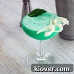 Grasshopper drink in a coupe glass with mint and white chocolate garnish
