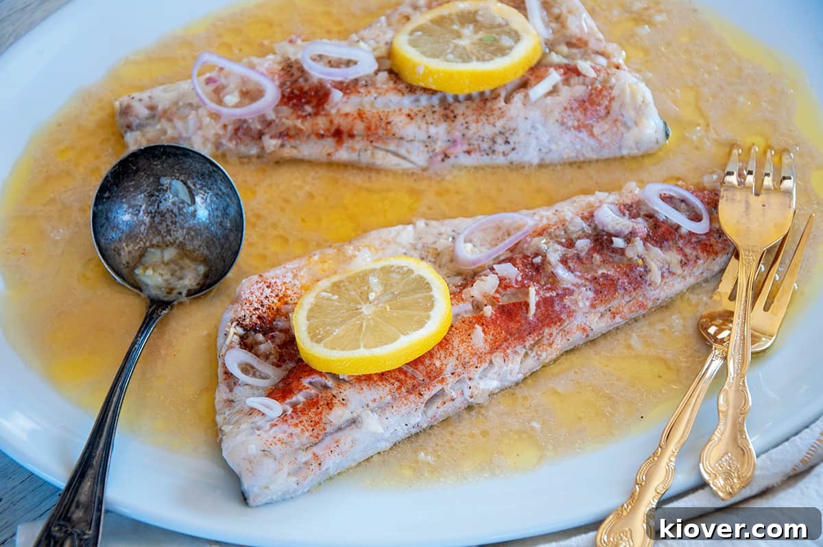 Two baked walleye filets on a large with plate.