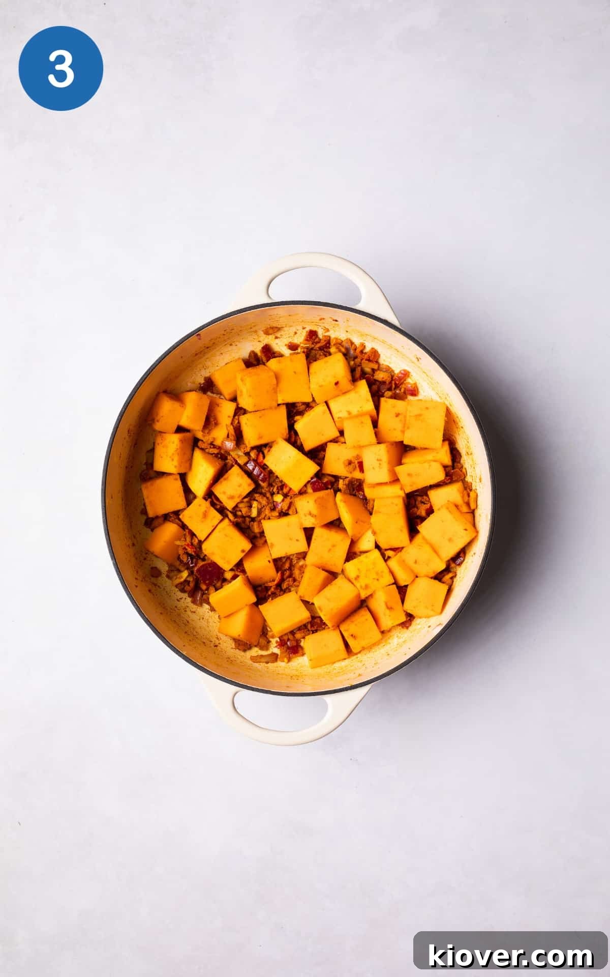 Butternut squash and spices added to the pot.