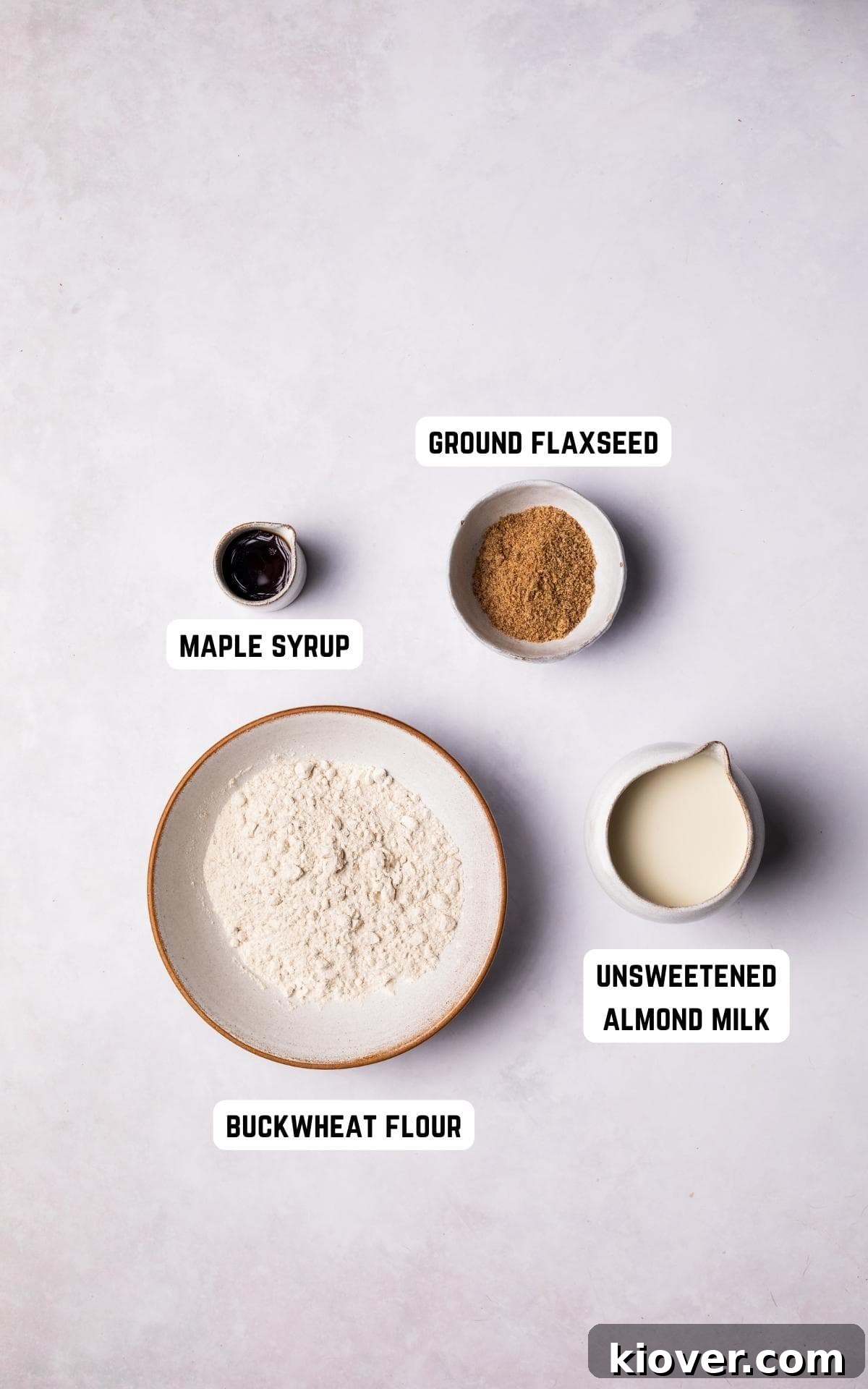 Ingredients to make Gluten Free Crepes on a white marble background.