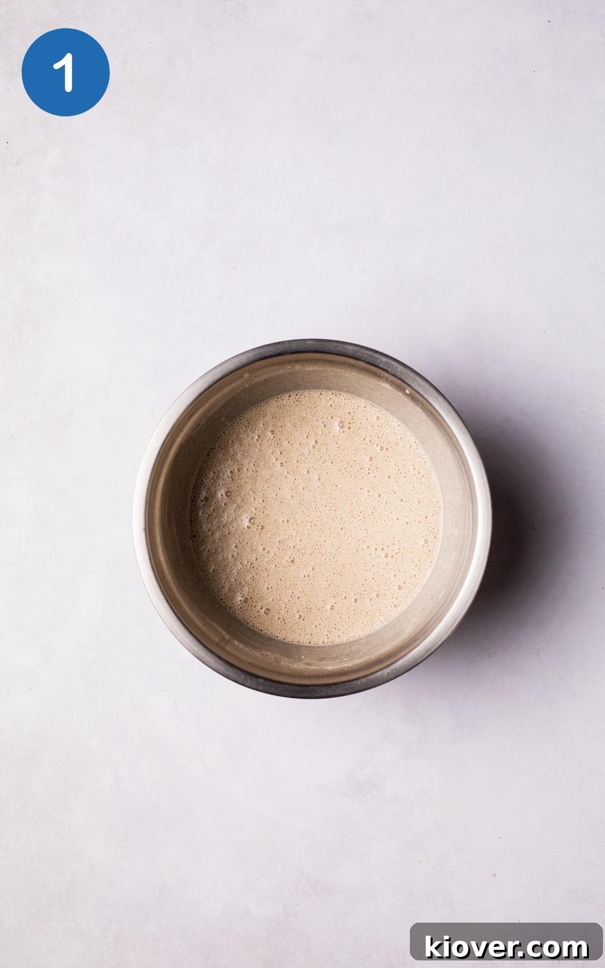 Ingredients for Gluten Free Crepes mixed in a large mixing bowl.