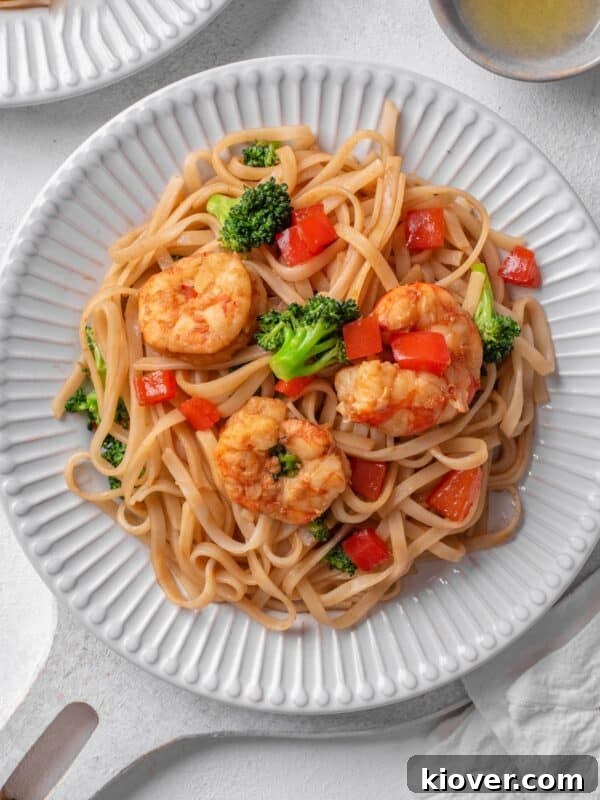 prawn noodles with broccoli and red pepper.