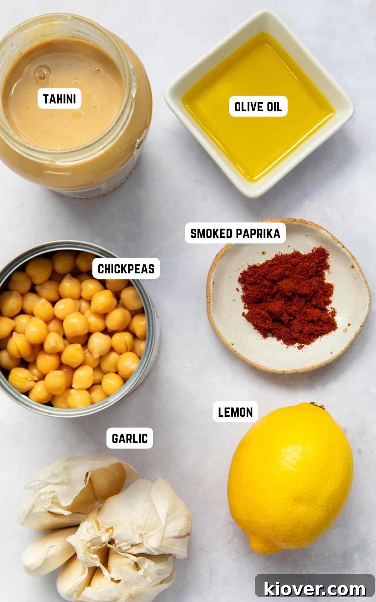 Creamy Garlic Hummus Recipe for Smooth, Flavorful Dip 3 homemade garlic hummus ingredients on a marble background.