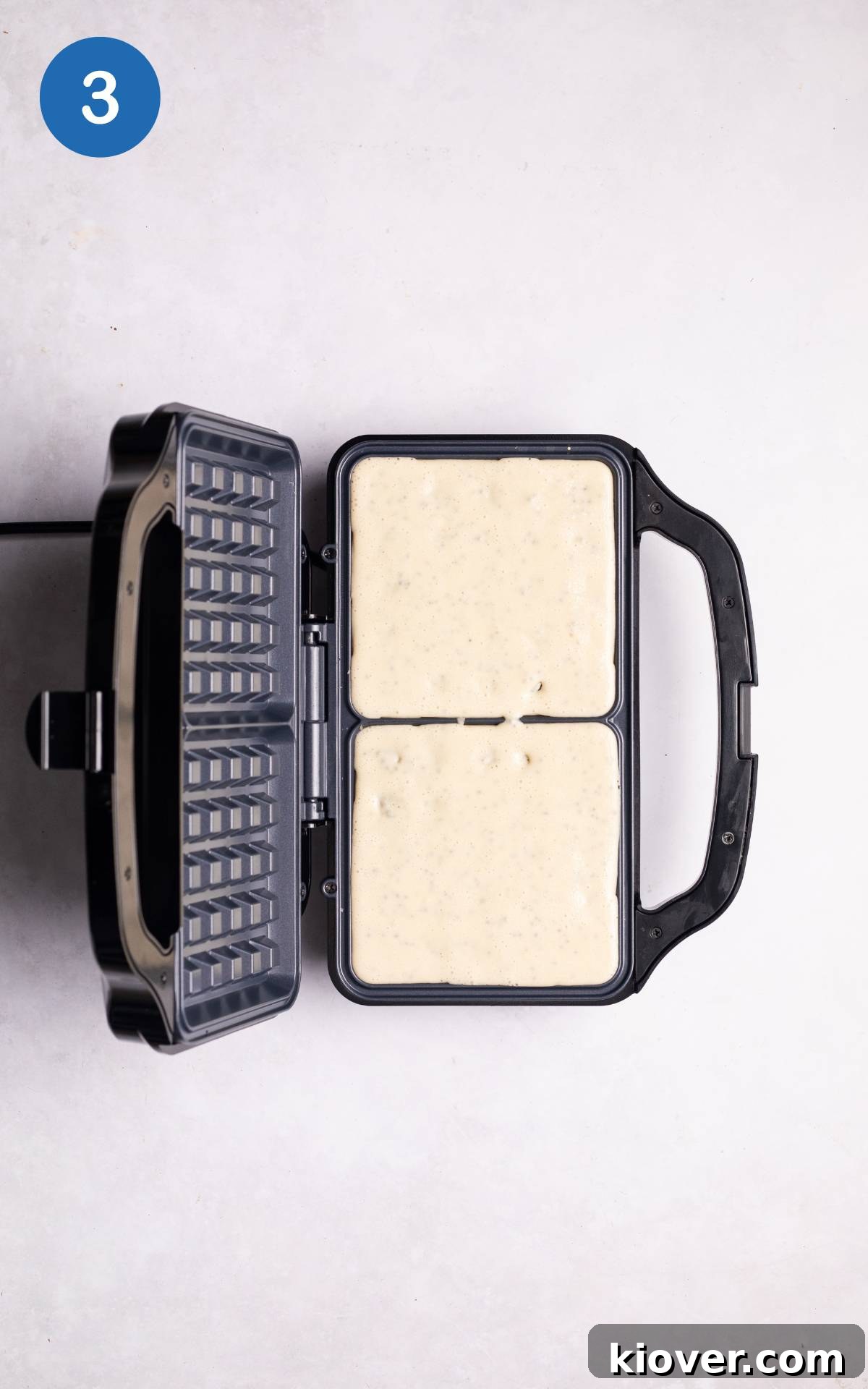 waffle mix in a waffle machine.