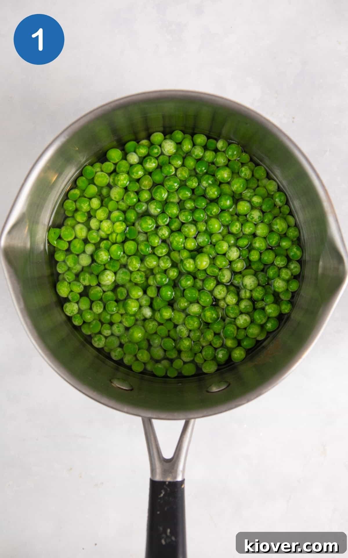 frozen peas boiling in a pot.