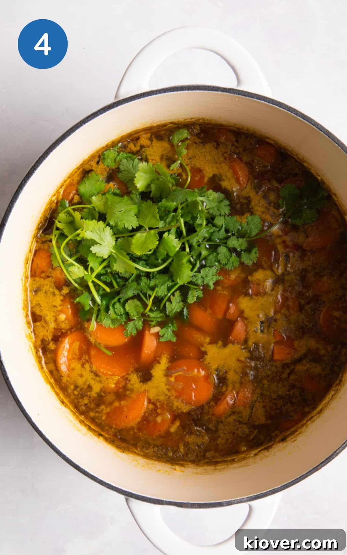 Carrot and Coriander Soup Recipe — Creamy Spiced Carrot Soup 7 added fresh coriander in the white pot ready to blend.