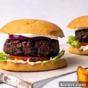 Juicy Portobello Mushroom Burger Recipe for Grill or Skillet 11 mushroom burgers in a bun with potato wedges on the side.