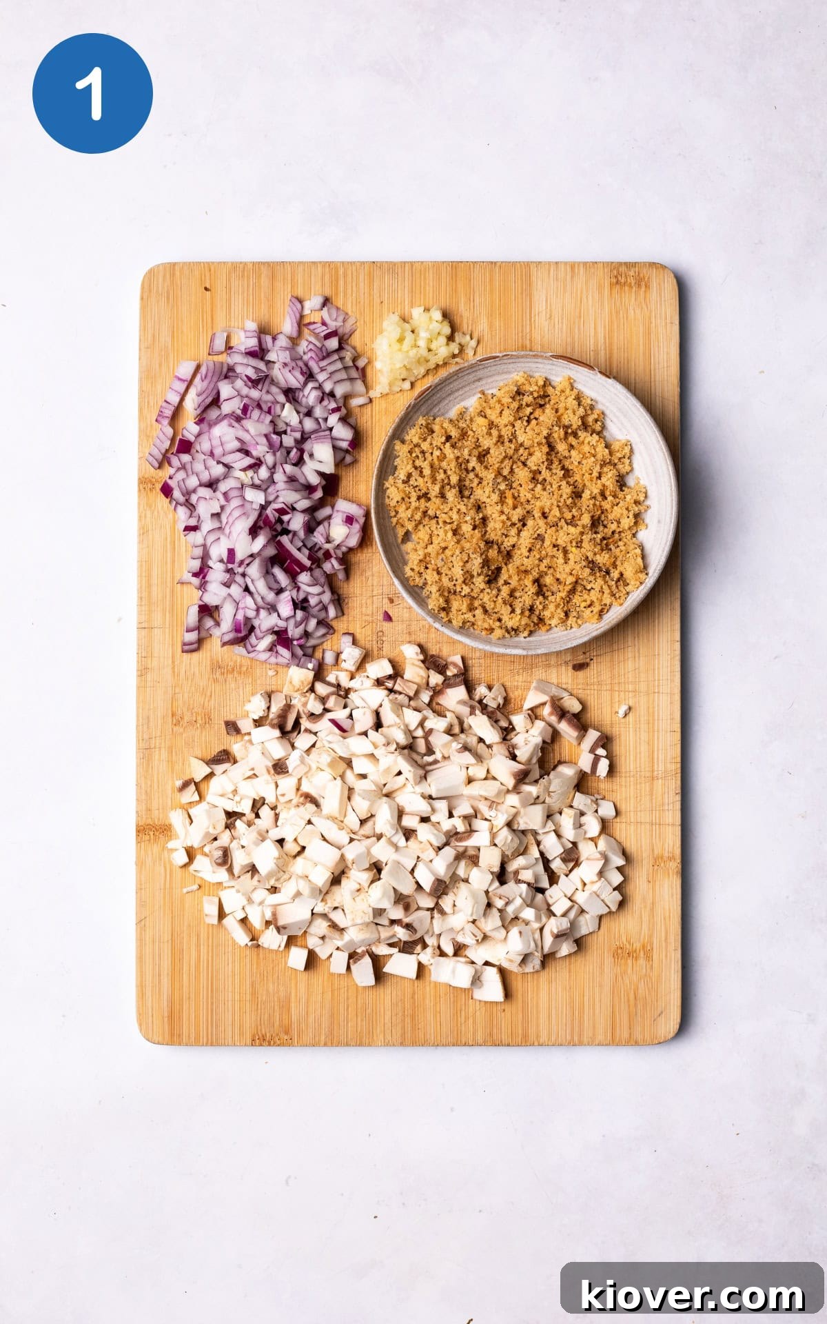 Juicy Portobello Mushroom Burger Recipe for Grill or Skillet 4 red onion, mushrooms, garlic and bread on a wooden cutting board.