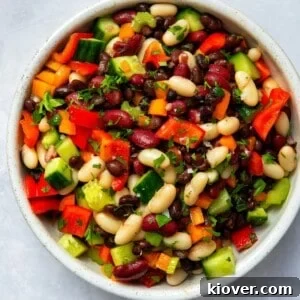 mixed bean salad in large bowl on white surface