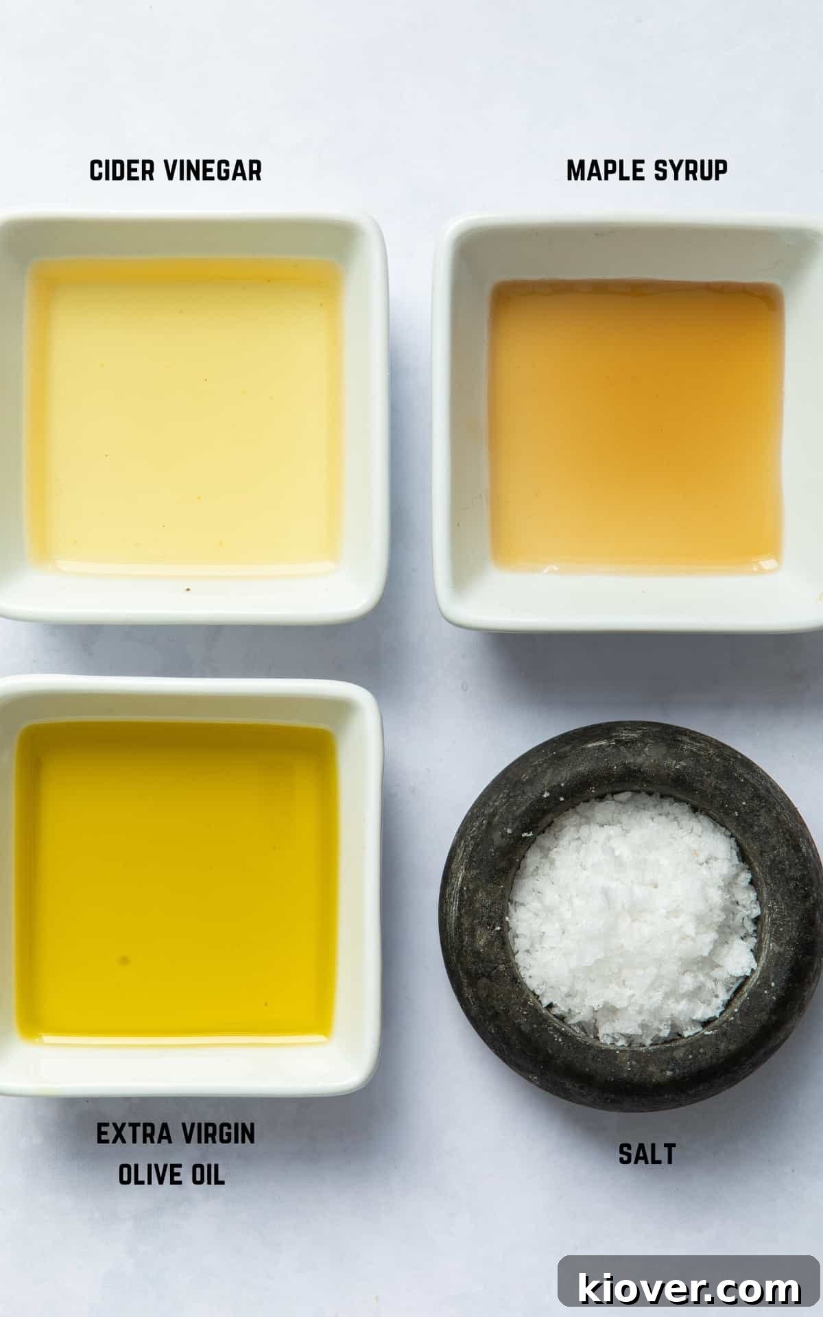 ingredients to make salad dressing on white surface.