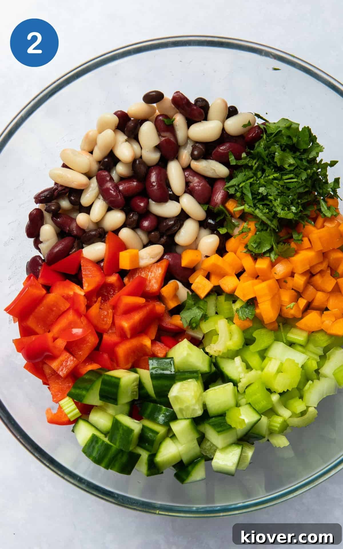 chopped carrot, cucumber, pepper, celery in a glass bowl.
