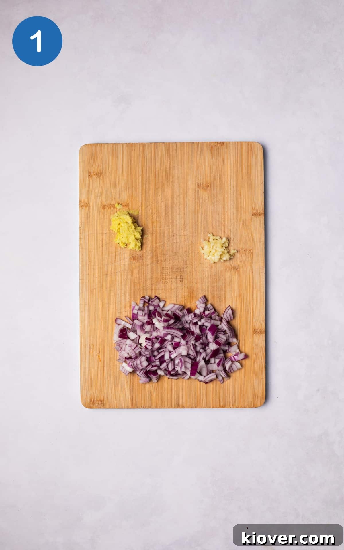 Classic Creamy Split Pea Soup Recipe for Cozy Meals 4 Chopped onion and ginger and crushed garlic on a cutting board.