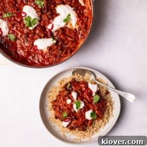 Hearty Vegan Chili Recipe with Beans and Smoky Spices 9 Vegan Chili served on a plate with brown rice.