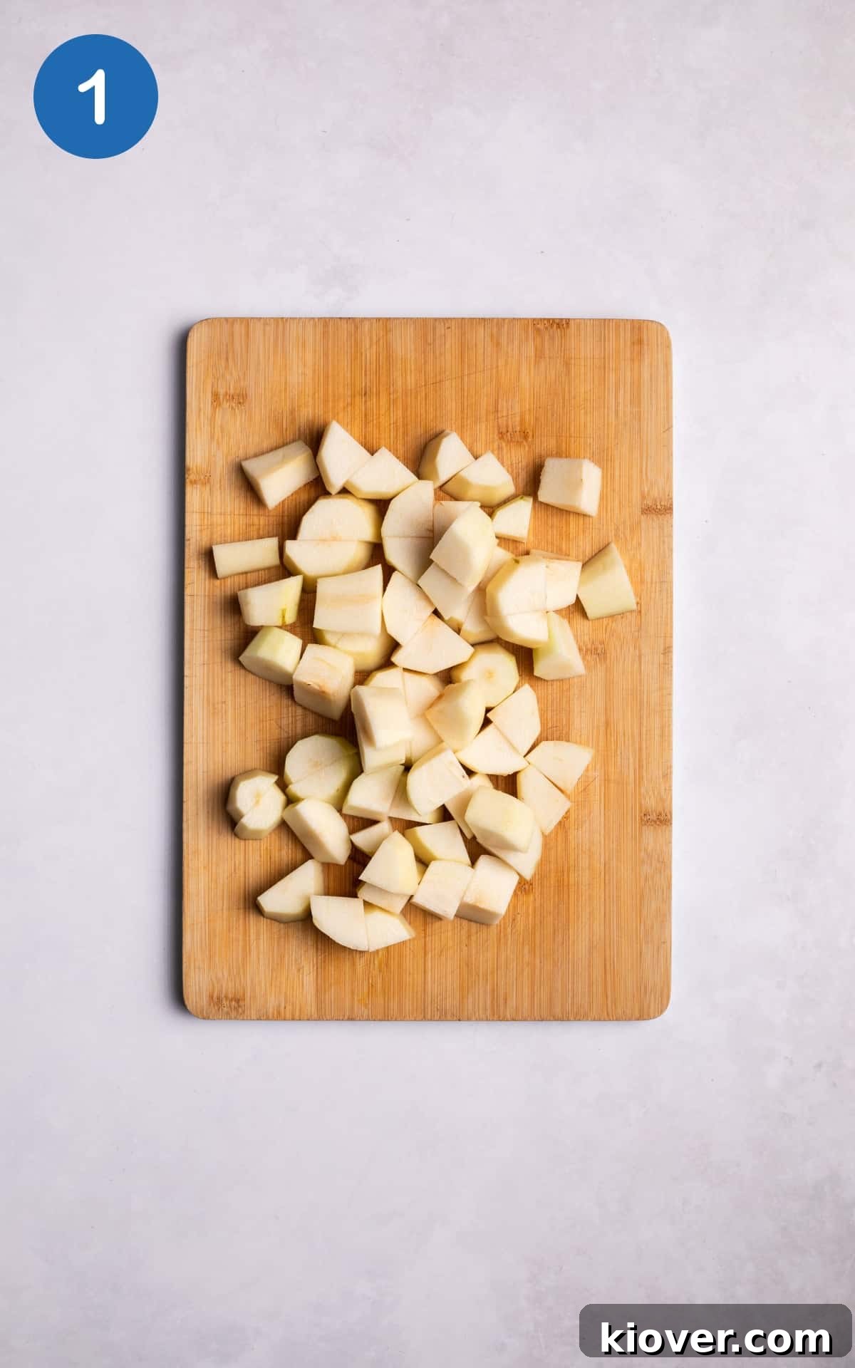 Chopped pears on a wooden cutting board.