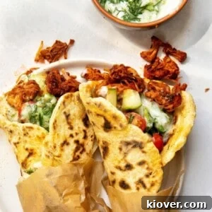 Two vegan gyros served on a plate.