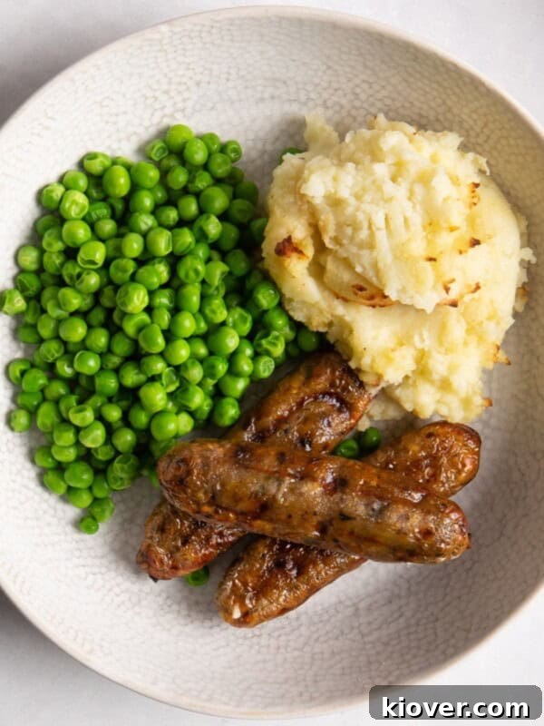 Creamy Sausage Gnocchi with Spinach and Parmesan 12 air fryer sausages in a bowl served with mash potato and peas.