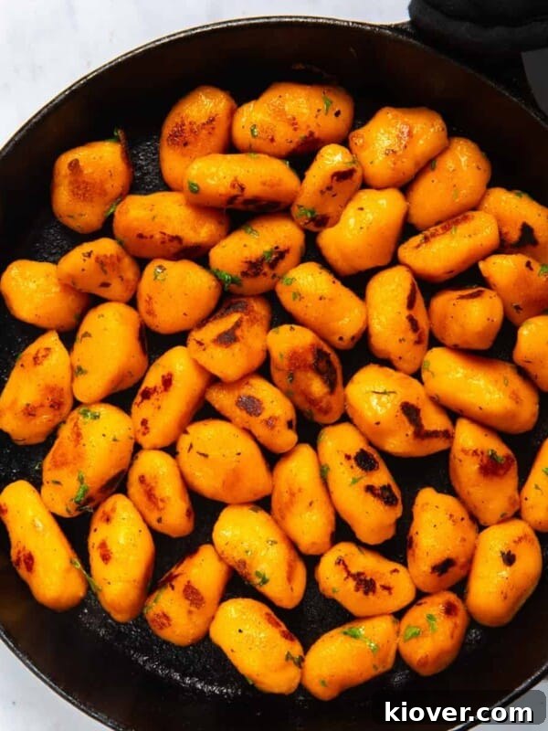Creamy Sausage Gnocchi with Spinach and Parmesan 9 Sweet Potato Gnocchi in black frying pan.