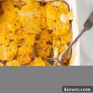 vegan dauphinoise potatoes in baking dish with spoon