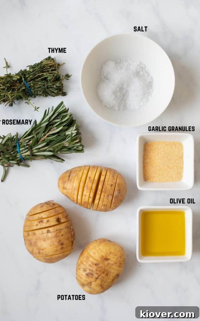 Crispy Hasselback Potatoes with Garlic and Parmesan 3 overhead view of labeled ingredients including thyme, rosemary, salt, garlic granules, potatoes, olive oil.