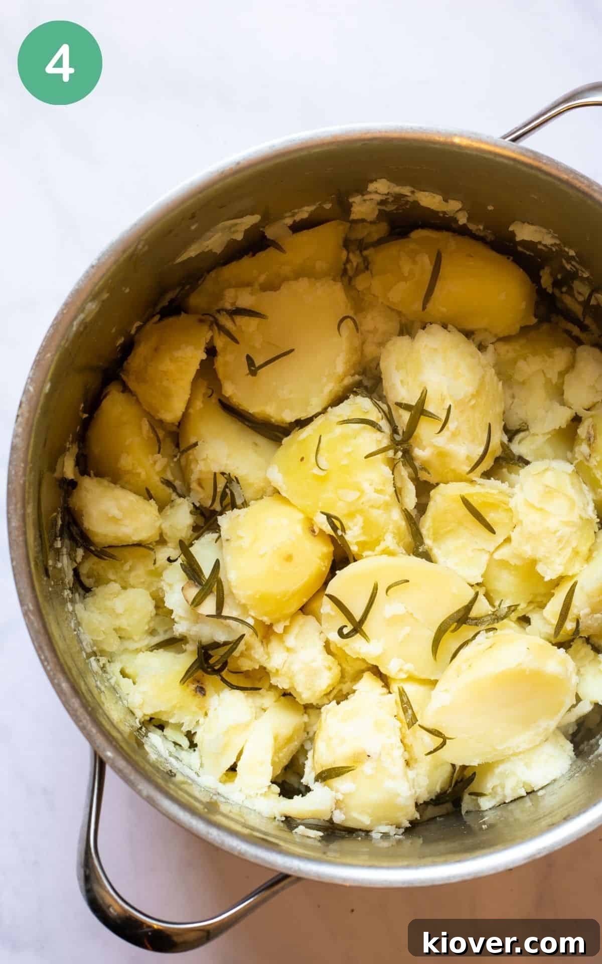 potatoes inside of a pot with rosemary.