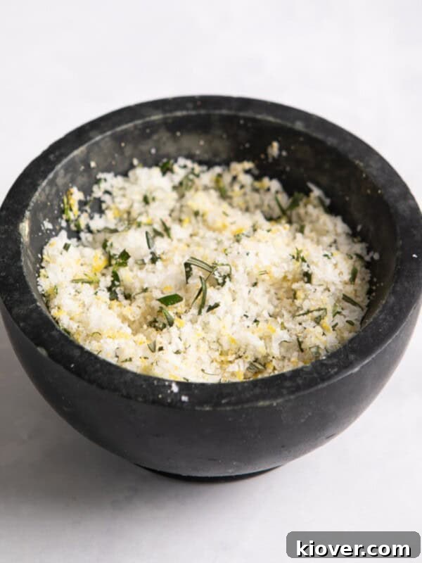 pot of rosemary salt in black pot on white surface.