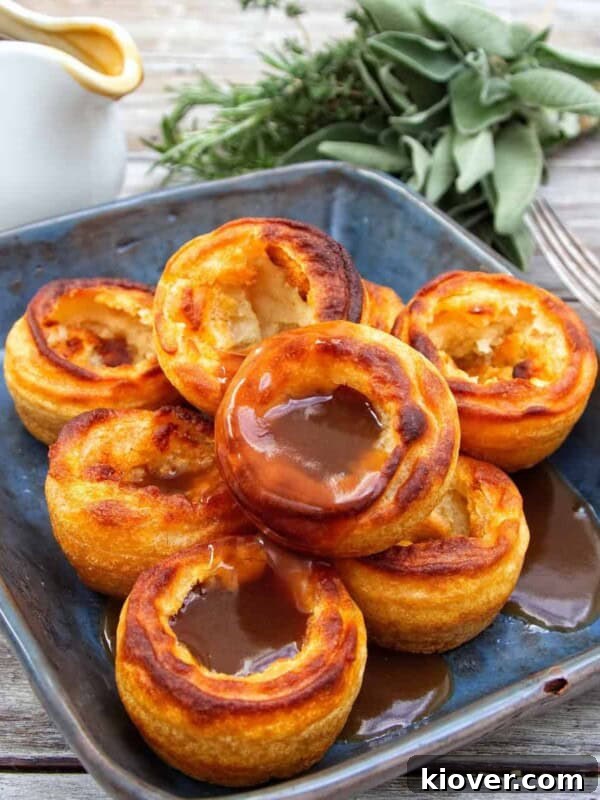Baked Pears with Honey and Cinnamon — Simple Warm Dessert 11 Yorkshire puddings towered on a blue/black plate covered in gravy.