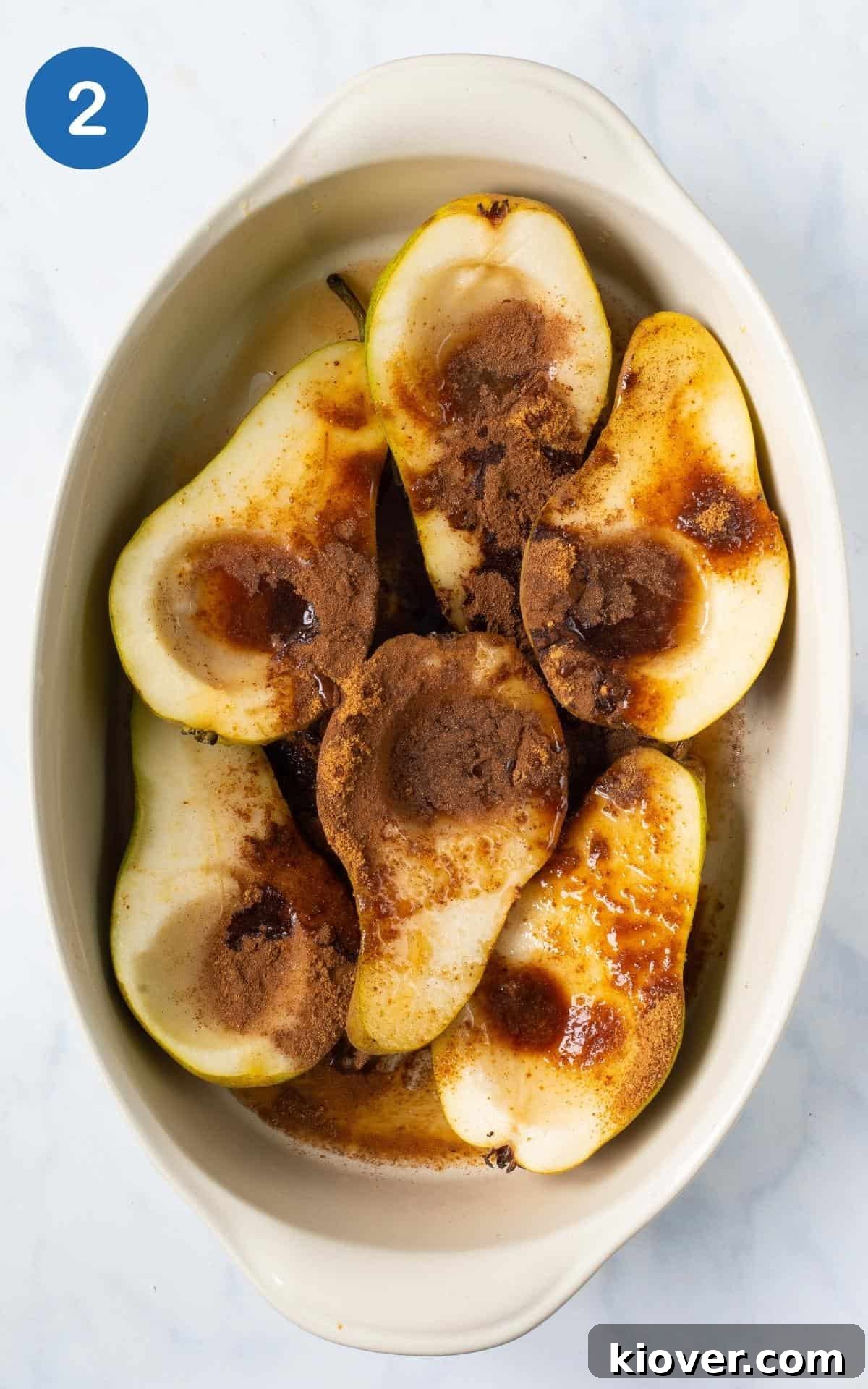 Baked Pears with Honey and Cinnamon — Simple Warm Dessert 5 pears in baking dish topped with spices, sugar ready to bake in white dish.