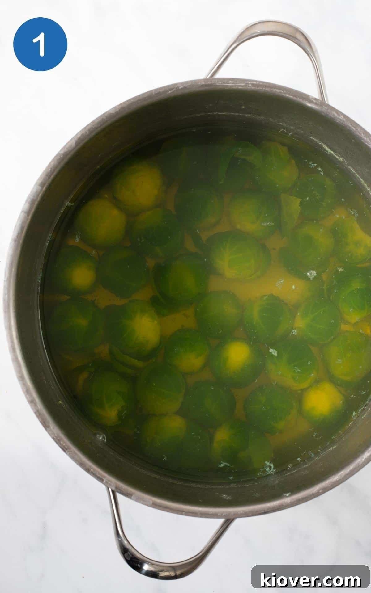 Crispy Smashed Brussels Sprouts with Garlic and Parmesan 4 top view of the sprouts being boiled in silver pot.