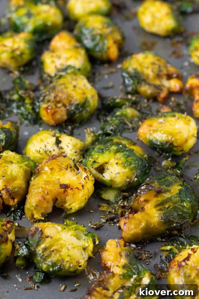Crispy Smashed Brussels Sprouts with Garlic and Parmesan 8 Crispy smashed Brussel Sprouts close up on baking tray front view.