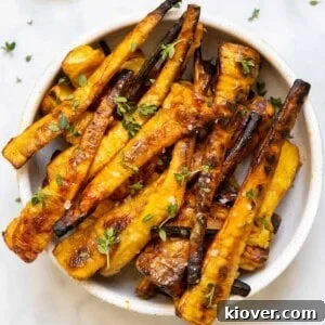 mustard maple glazed parsnips in white bowl on backdrop