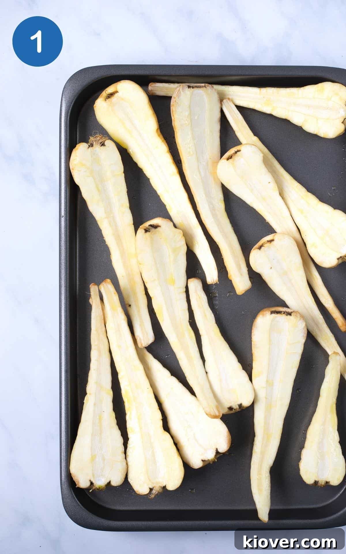 slice parsnips on baking tray with olive oil and salt ready to bake.
