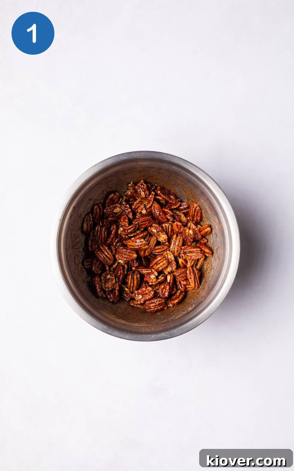 Sweet Cinnamon Candied Pecans Recipe for Gift Giving 4 Coating the pecans with other ingredients in a mixing bowl.