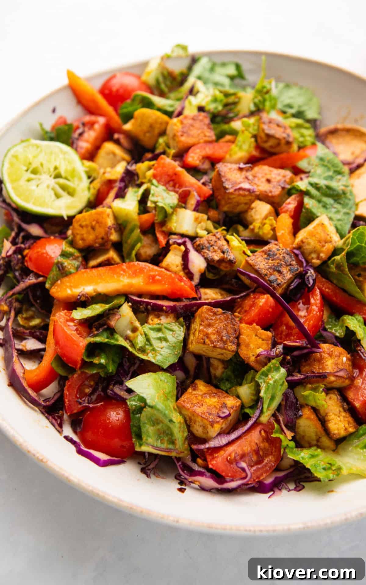 healthy tofu salad with fresh vegetables on a plate.