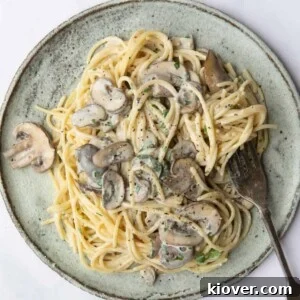 Creamy Vegan Mushroom Pasta Recipe for Dinner Nights 14 Vegan Mushroom Pasta served on a blue plate with a silver fork
