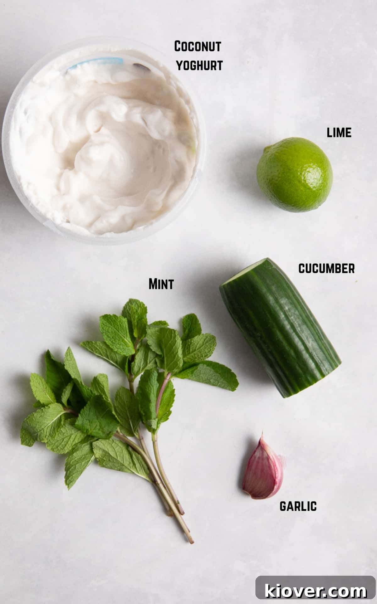 Creamy Vegan Tzatziki Sauce Recipe for Mediterranean Dishes 3 ingredients to make Tzatziki on white surface.