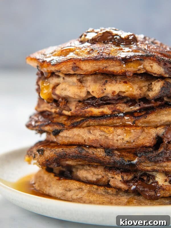 Fluffy Banana Oat Pancakes Recipe for Quick Morning Meals 8 gluten free banana pancakes stacked on a white plate