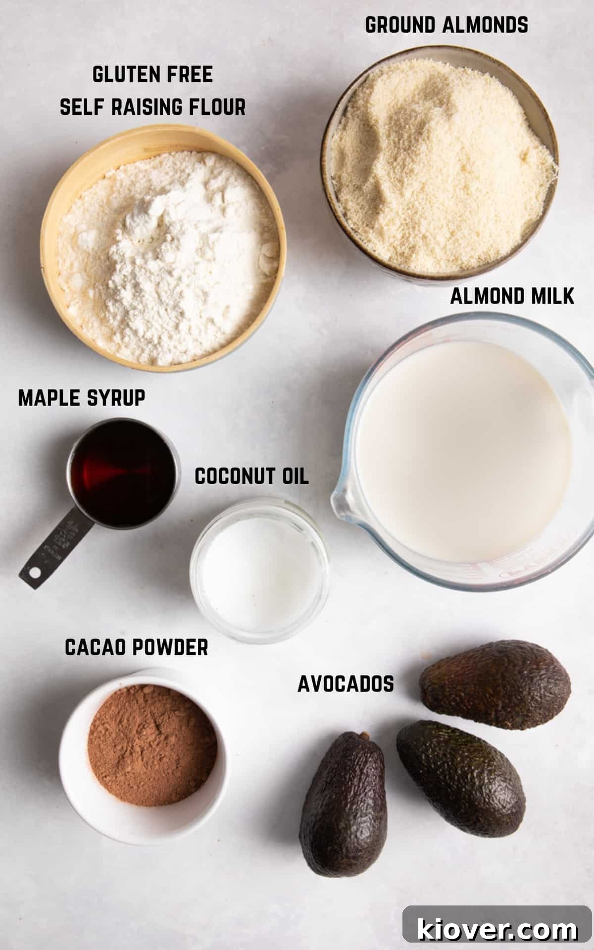 Ingredients to make chocolate cake on white background.