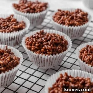 No-Bake Rice Krispie Treat Cakes Recipe for Parties and Gifts 14 rice crispy cakes on a cooling rack.