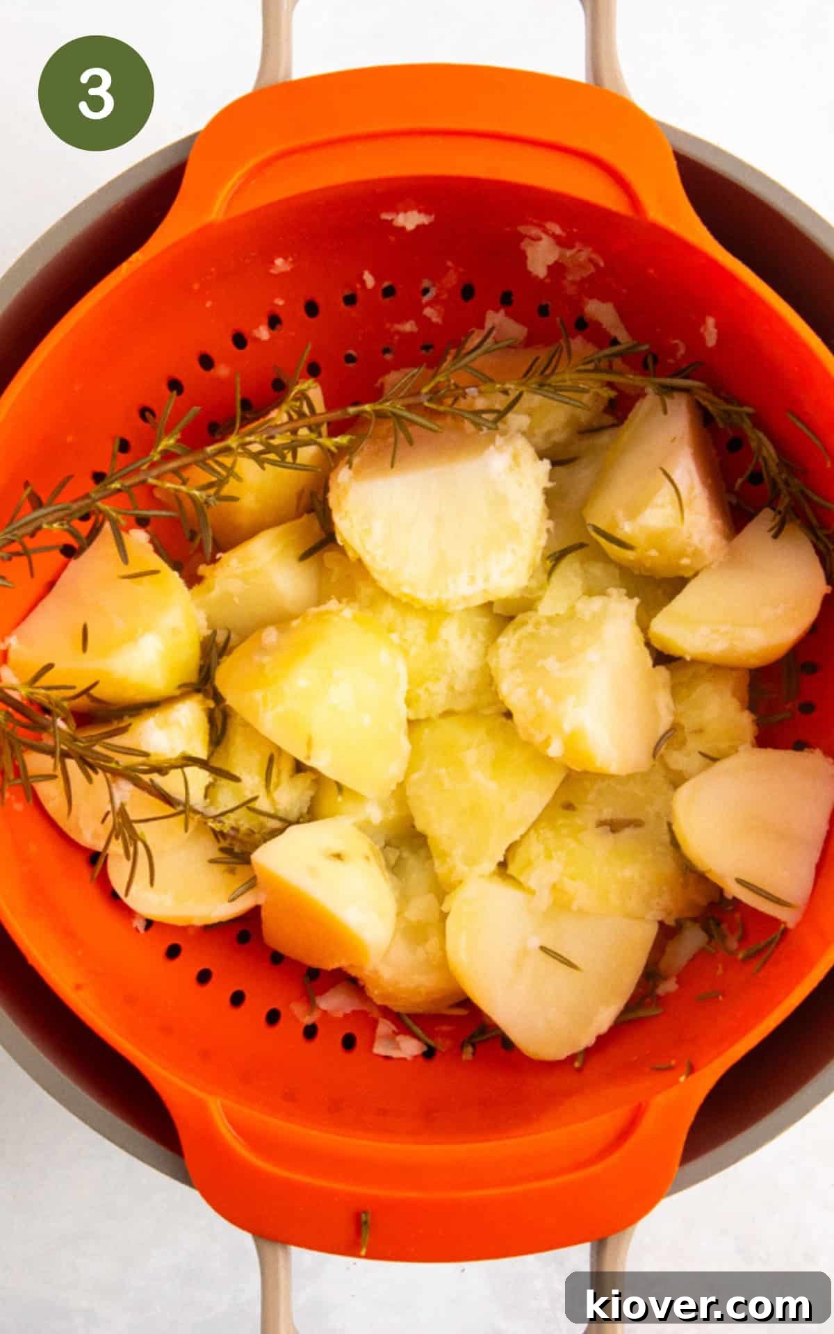 Crispy Air Fryer Roast Potatoes Recipe for Perfect Sides 6 drained potatoes with rosemary in a colander.