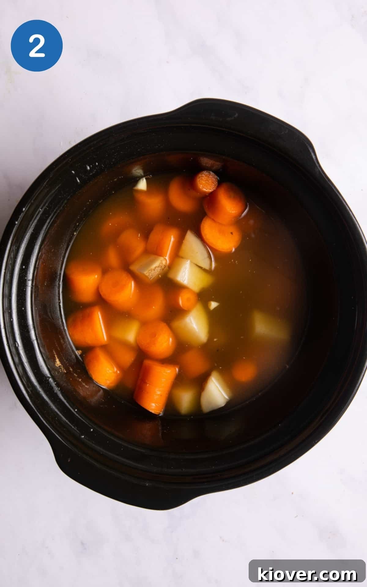 Slow Cooker Carrot and Coriander Soup Recipe for Comforting Flavor 5 All ingredients to make soup within black slow cooker before cooking.