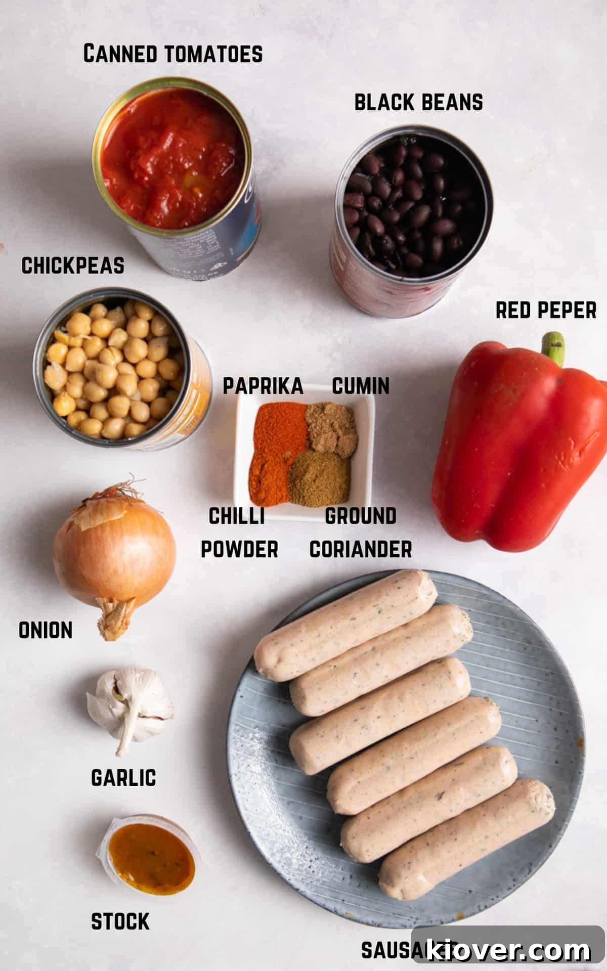 Ingredients to make Slow Cooker Sausage Casserole on white marble background.