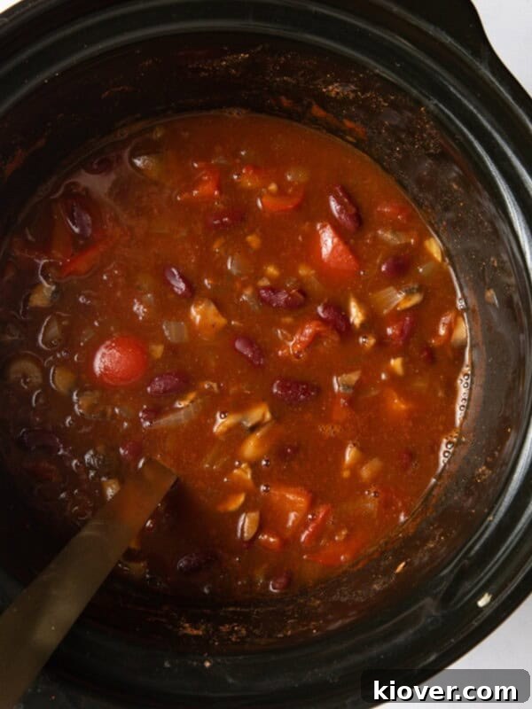 overhead shot of chilli with ladle in slow cooker