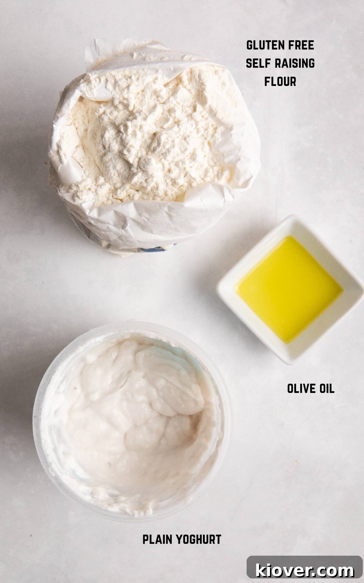 Flour, yoghurt and olive oil on white marble surface.